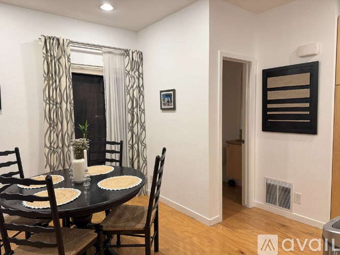 A dining room with a table set for four.
