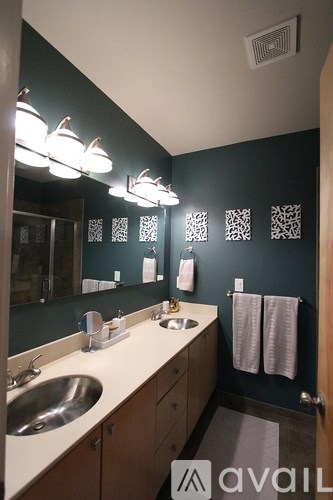A bathroom with a sink, mirror, and towel rack.