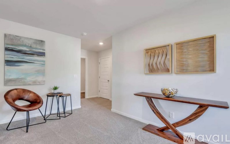 A living room with a brown chair and a wooden table.