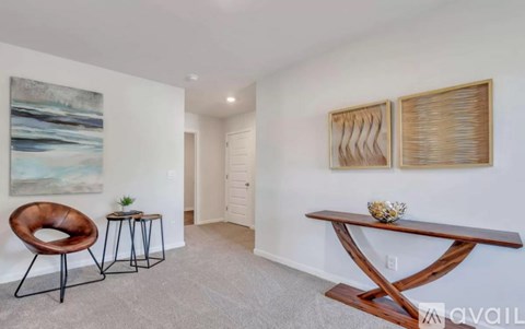 A living room with a brown chair and a wooden table.