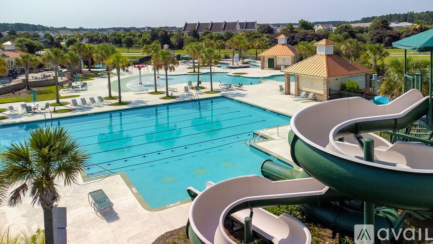 A large outdoor swimming pool with a slide.