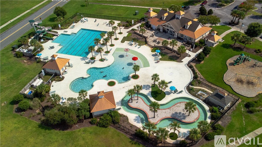 An aerial view of a resort with a large pool and a water slide.