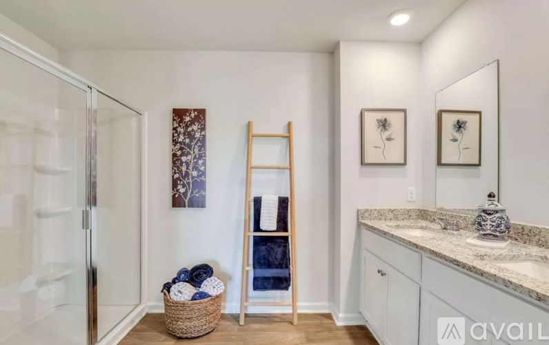 A bathroom with a mirror, sink, and a ladder.