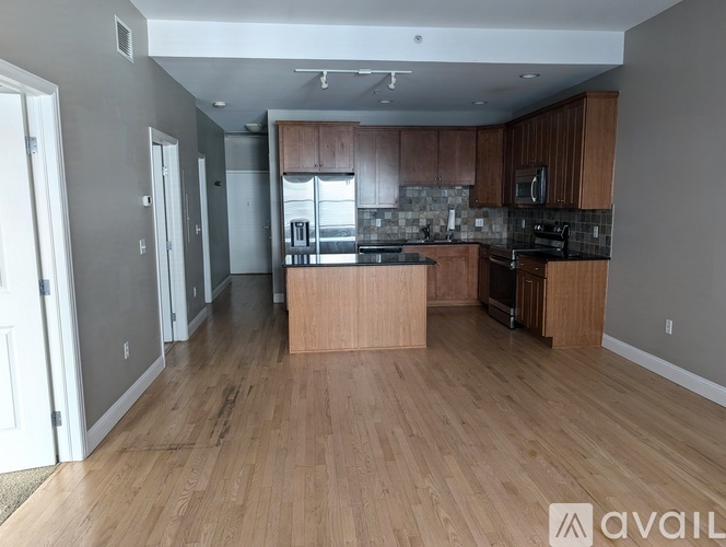 A kitchen with wooden floors and a countertop.