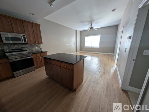 A kitchen with wooden cabinets and a black countertop.