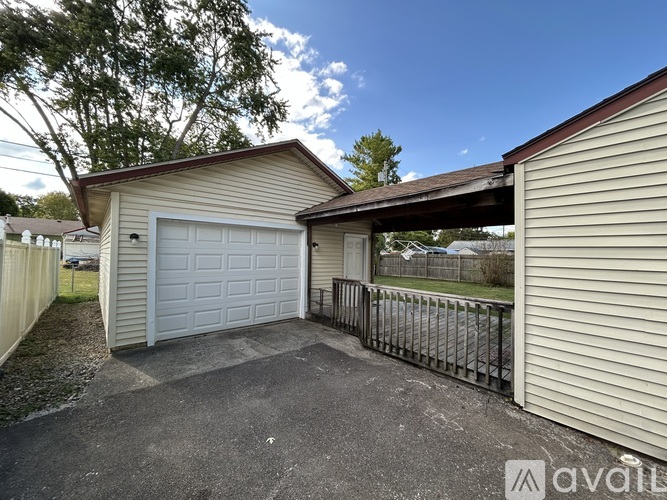 A detached house with a garage is for sale.