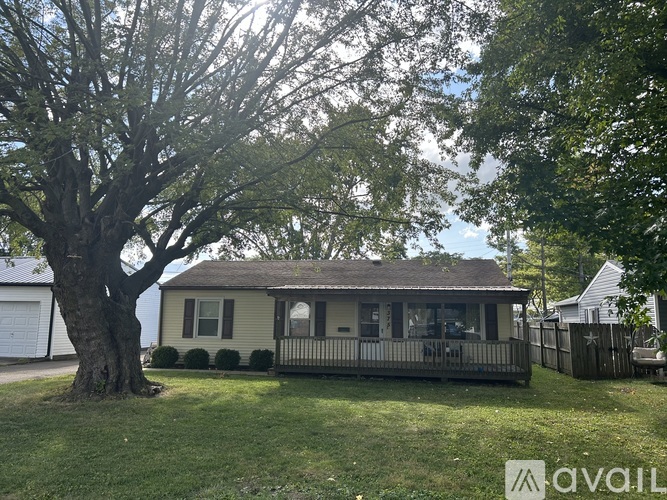 A house with a tree in front of it.