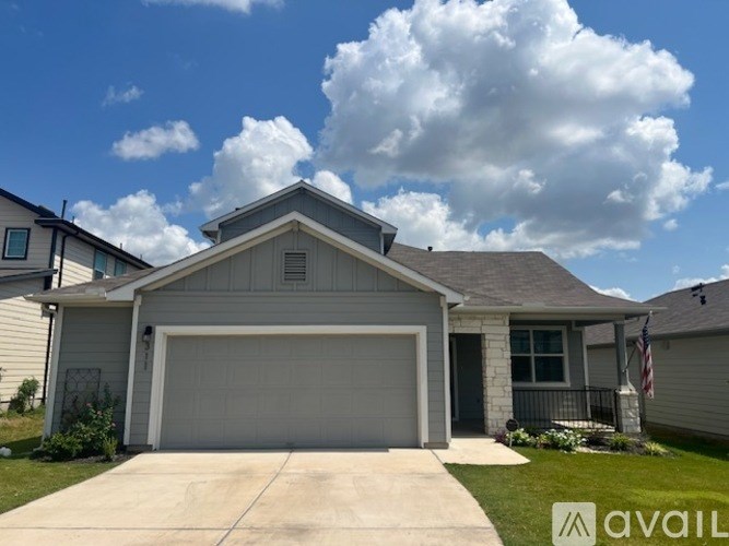 A house with a garage and a flag on the front porch.