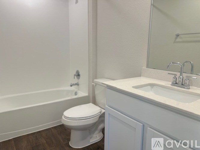 A white toilet sits next to a sink in a bathroom.