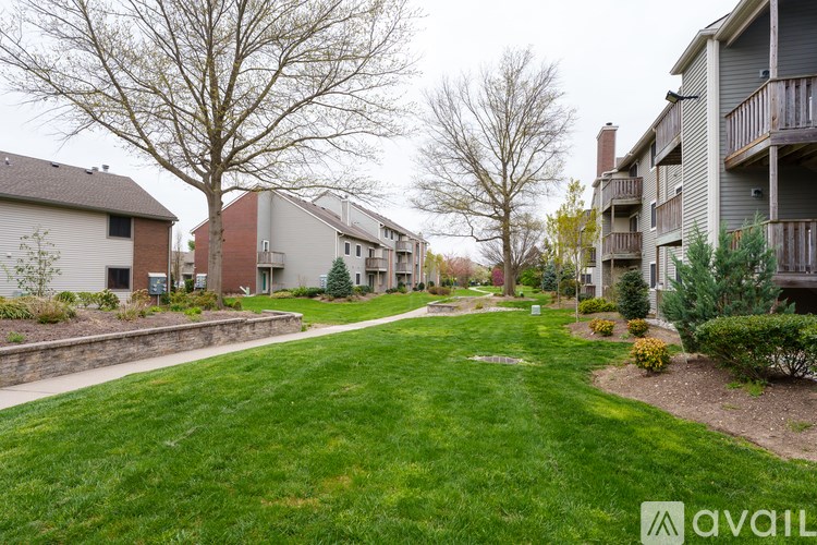 A grassy area in front of apartment buildings.