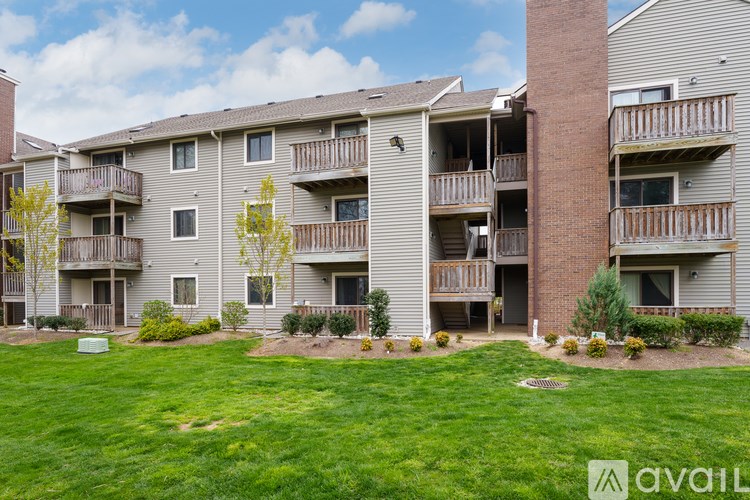 Apartment complex with green grass in front.