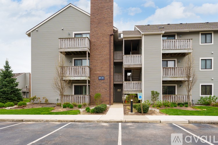 Apartment building with a blue sign on the front.