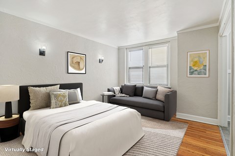 A bedroom with a large bed and a couch.