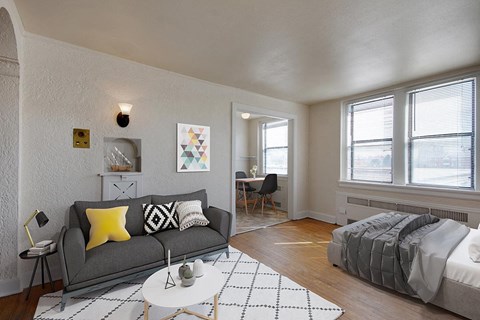 A living room with a grey couch and a white coffee table.