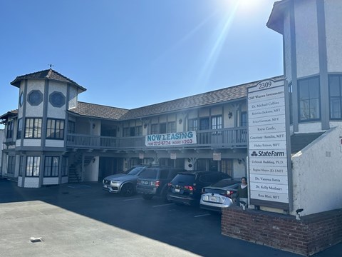 A sunny day at the Statewide Financial Services building with cars parked in front.