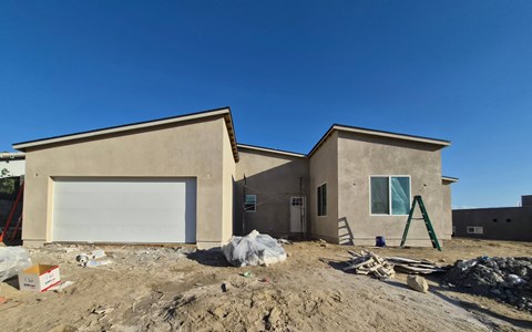A house under construction with a clear blue sky.