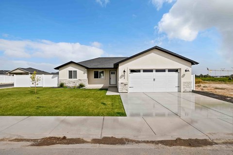 A house with a white garage door and a black roof.