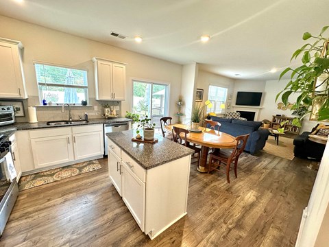 A kitchen with a dining table and chairs.