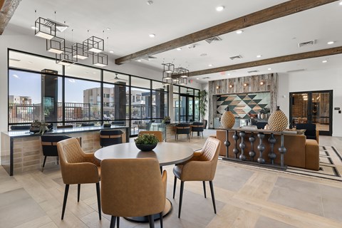 A modern dining room with a round table and chairs.