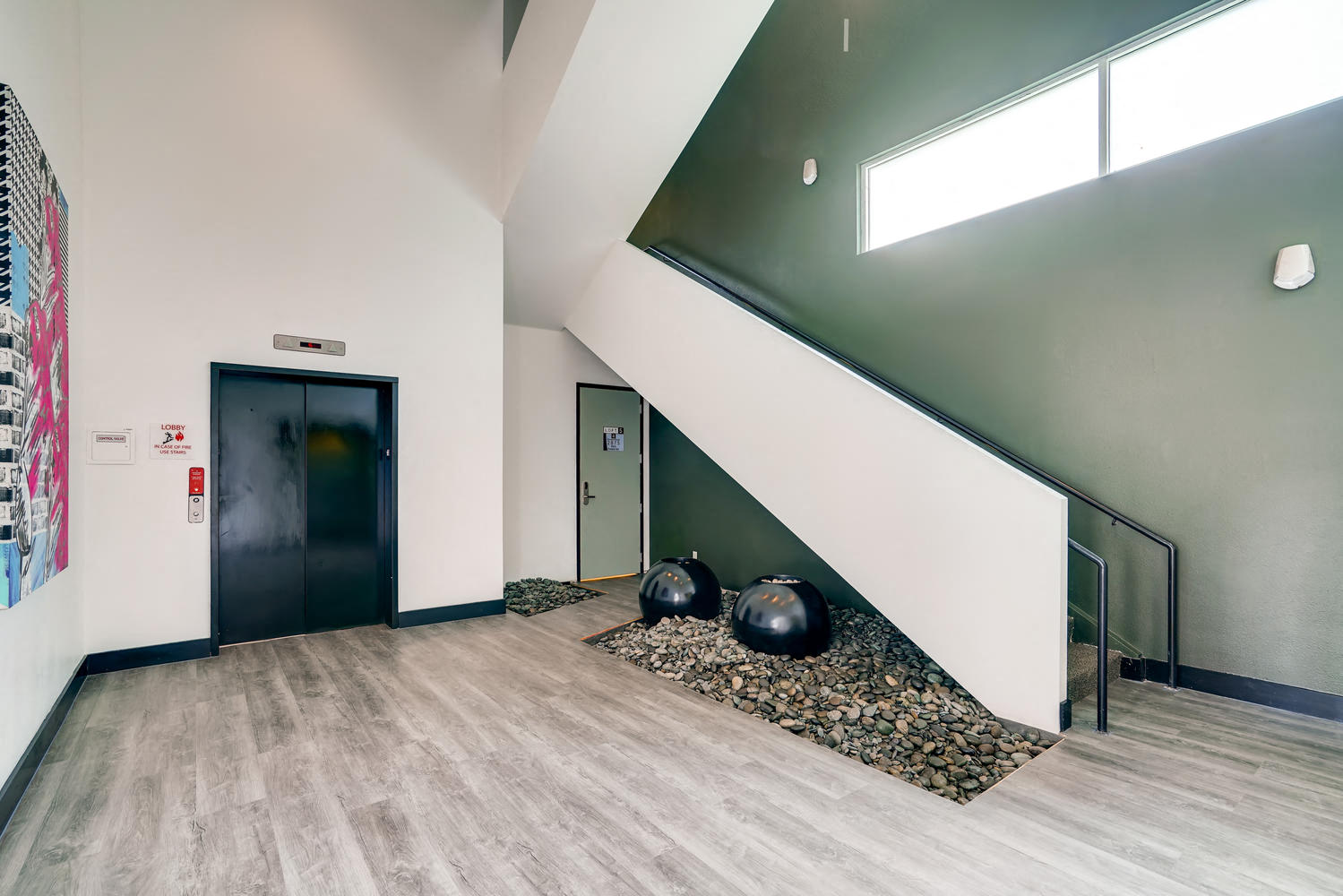 the lobby of a building with two balls on the floor