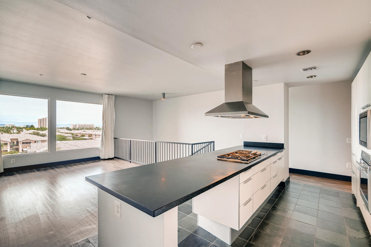 a kitchen with a large counter top and a large window
