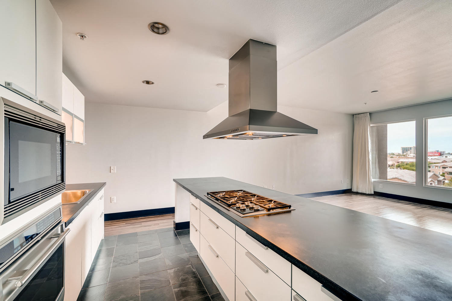 a kitchen with an island and a stove and a microwave