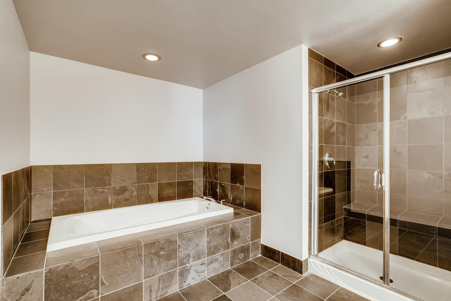 a bathroom with a tub and a shower