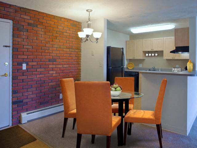 a dining room with a table and chairs