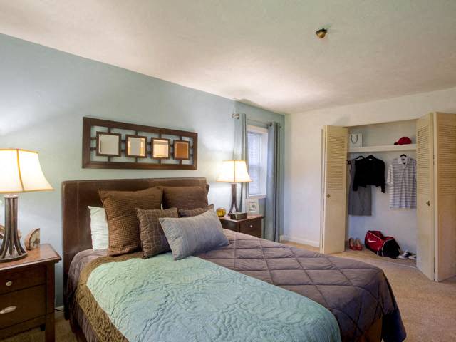 a bedroom with a large bed and a closet