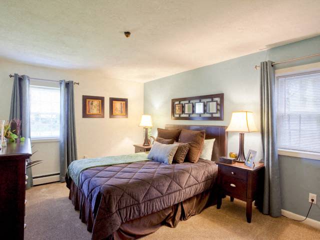 a bedroom with a bed and two lamps