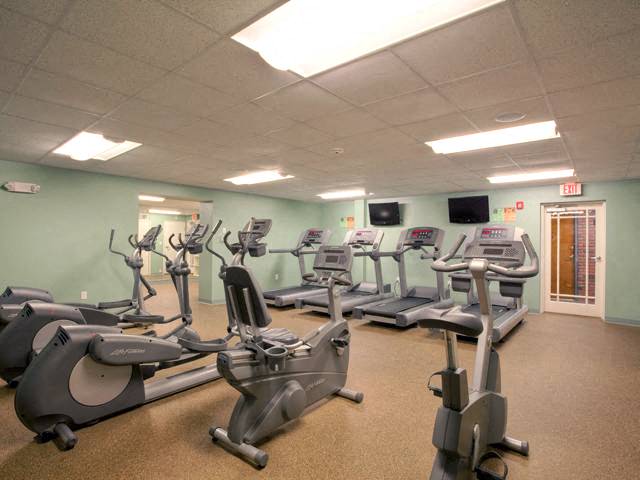 a gym with a bunch of exercise equipment in it