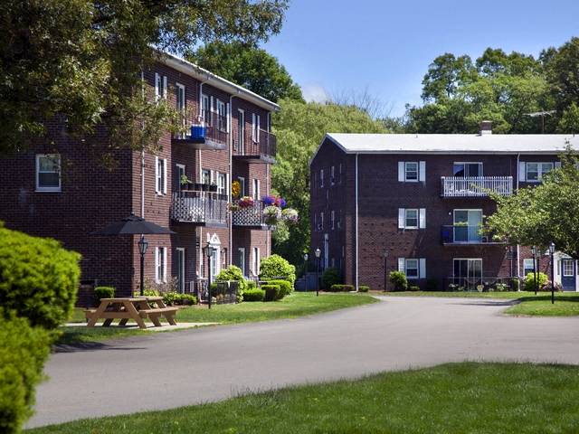 a brick apartment building with a picnic table