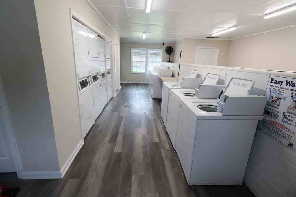 A laundry room with washers and dryers.