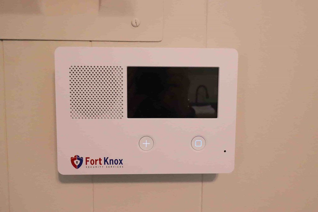 A Fort Knox security device is mounted on a wall.