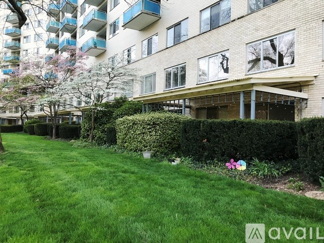 Apartment building with a green lawn in front.