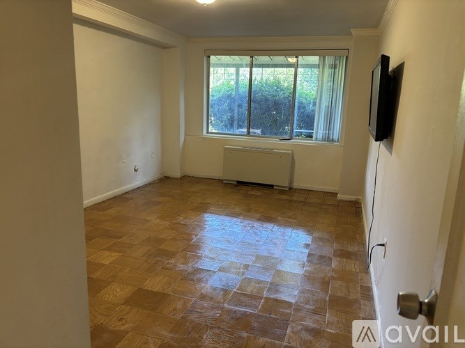 A room with a window and a radiator on the wall.