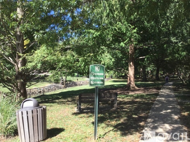 A sign in a park says "NO PETS" and "NO BIKES".