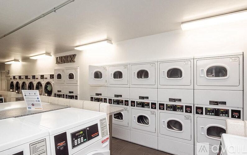 A row of washing machines in a laundromat.