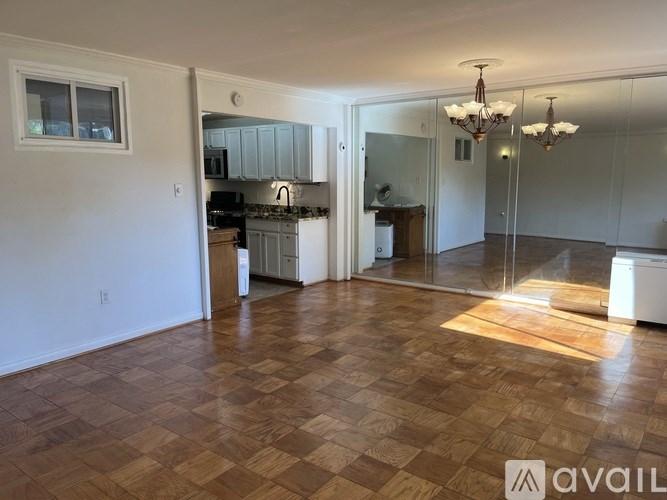 A kitchen with a checkered floor and a chandelier.