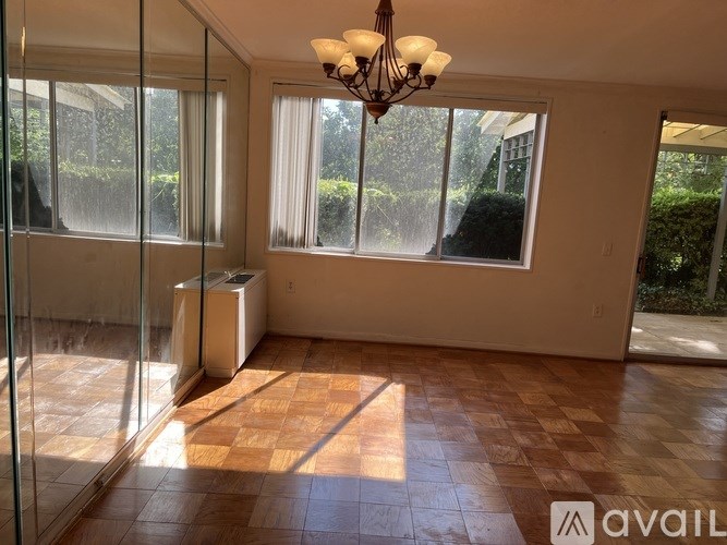 A room with a tiled floor and a chandelier hanging from the ceiling.
