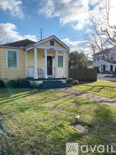 A small yellow house with a white door and windows is for sale.