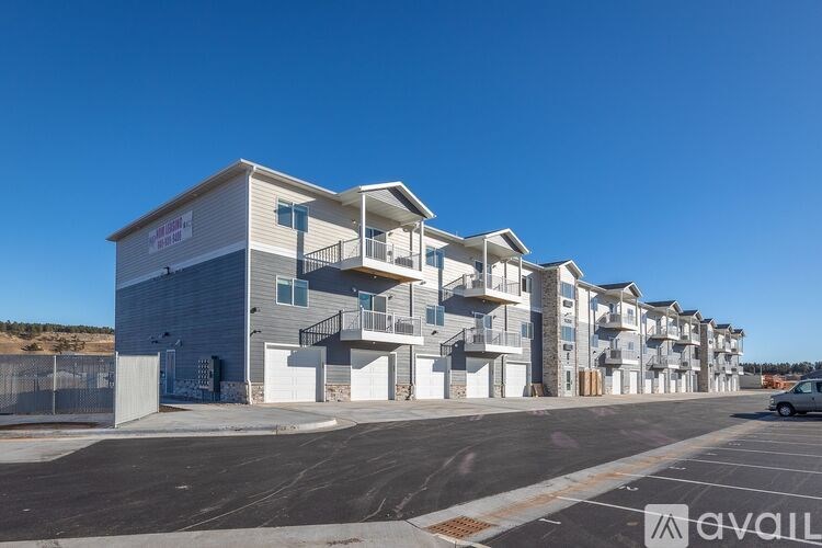 A row of modern townhouses with a clear blue sky above.
