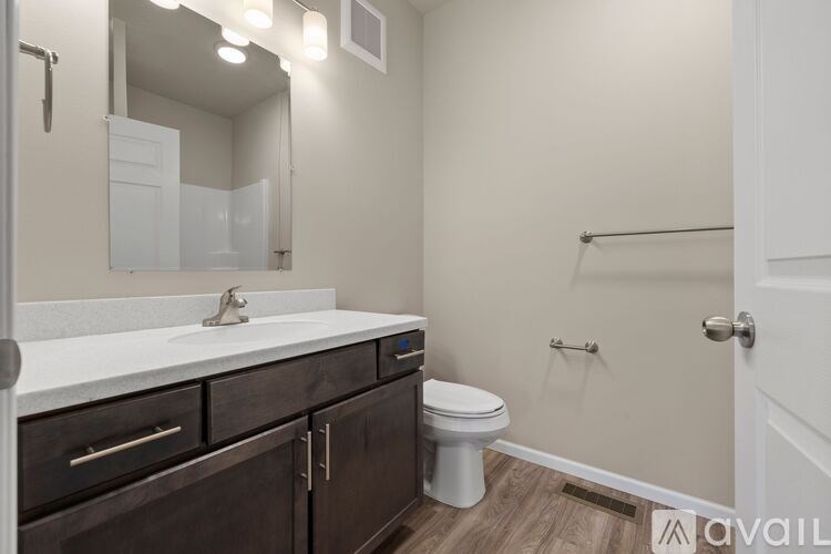 A bathroom with a white sink and a white toilet.