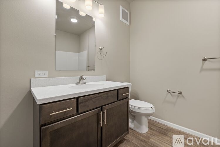 A bathroom with a white sink and a toilet.