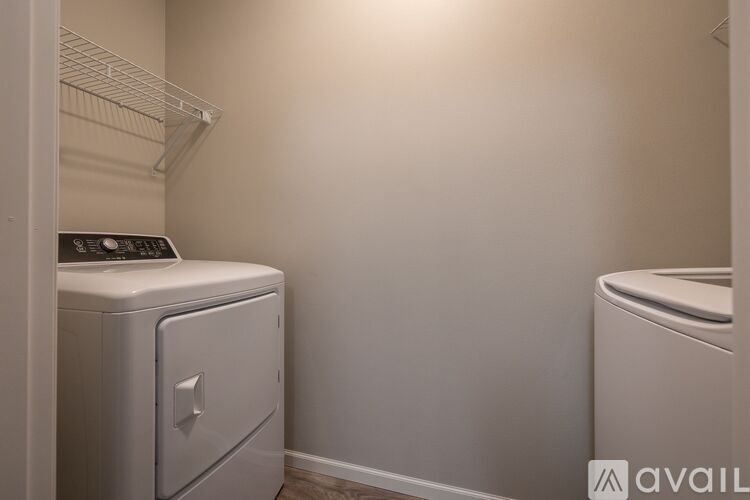 A small laundry room with a washer and dryer.