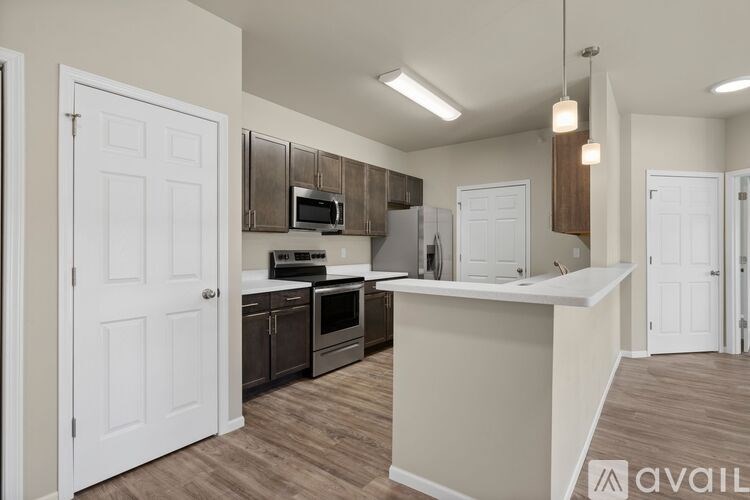 A kitchen with a white door and a counter.