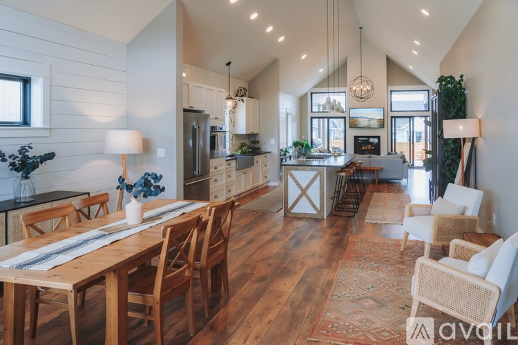 A modern kitchen with wooden floors and furniture.