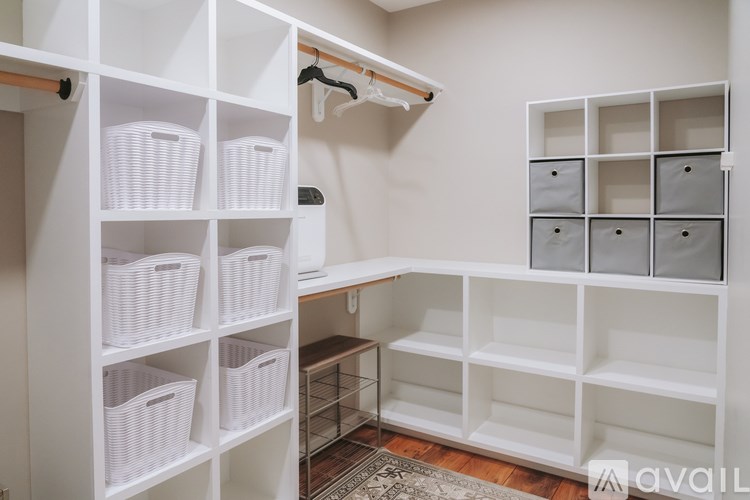 A white closet with shelves and baskets.