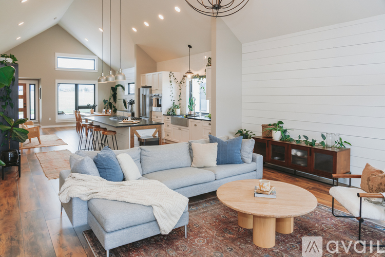 A living room with a grey couch and a wooden coffee table.