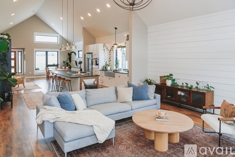 A living room with a grey couch and a wooden coffee table.